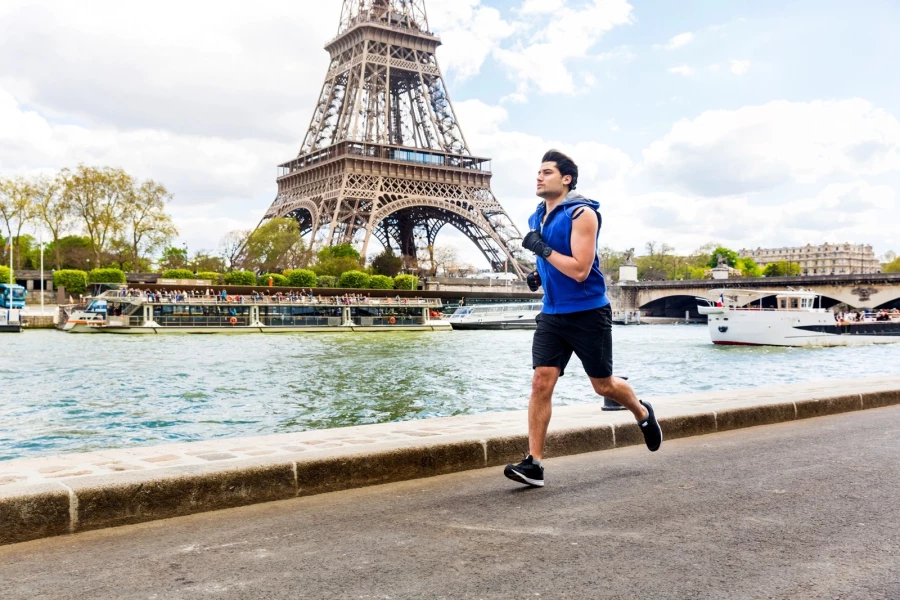 Man jogging near the Eiffel Tower in Paris Man jogging near the Eiffel Tower in Paris